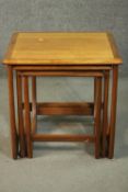 A circa 1970s nest of three teak G-Plan style tables, with crossbanded tops. H.51 W.50 D.49cm.