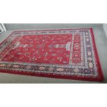 A woollen Keshan motif carpet, on a red ground. L.290 W.200cm.