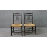 A pair of 19th century Sussex style ebonised ash side chairs, with turned spindle backs, over rush