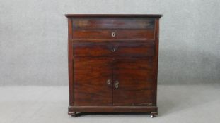 A 19th century French mahogany washstand, the rising lid revealing a white marble surface, over a