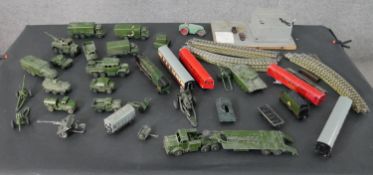 A collection of Hornby trains, track and control centre along with Dinky die cast army vehicles.