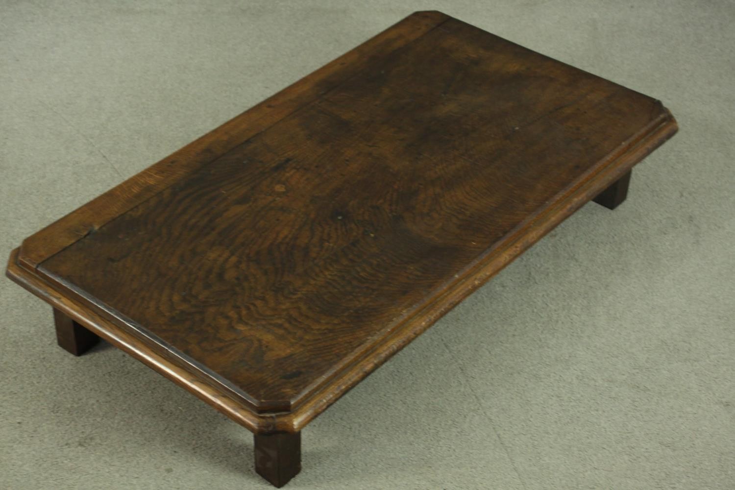 An elm low coffee table, of rectangular form with canted corners and a moulded edge, on square - Image 6 of 8