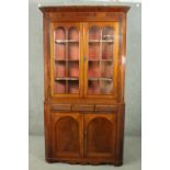 A George III mahogany corner display cabinet, with two glazed doors, over three short drawers, above