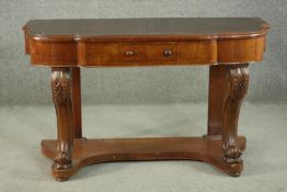 A Victorian Duchess style walnut dressing table, the shaped top with a central breakfront drawer, on