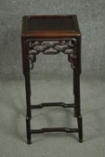 A 19th century Chinese rosewood jardiniere stand, with a square top, over a pierced frieze, the legs