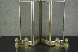 A pair of brass fire dogs, with pineapple finials, together with a brass four fold fire screen. H.63