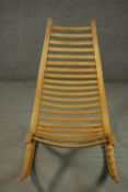 A Robin Williams 1970's oak 'Wishbone' rocking chair, of slatted construction and ergonomic design.
