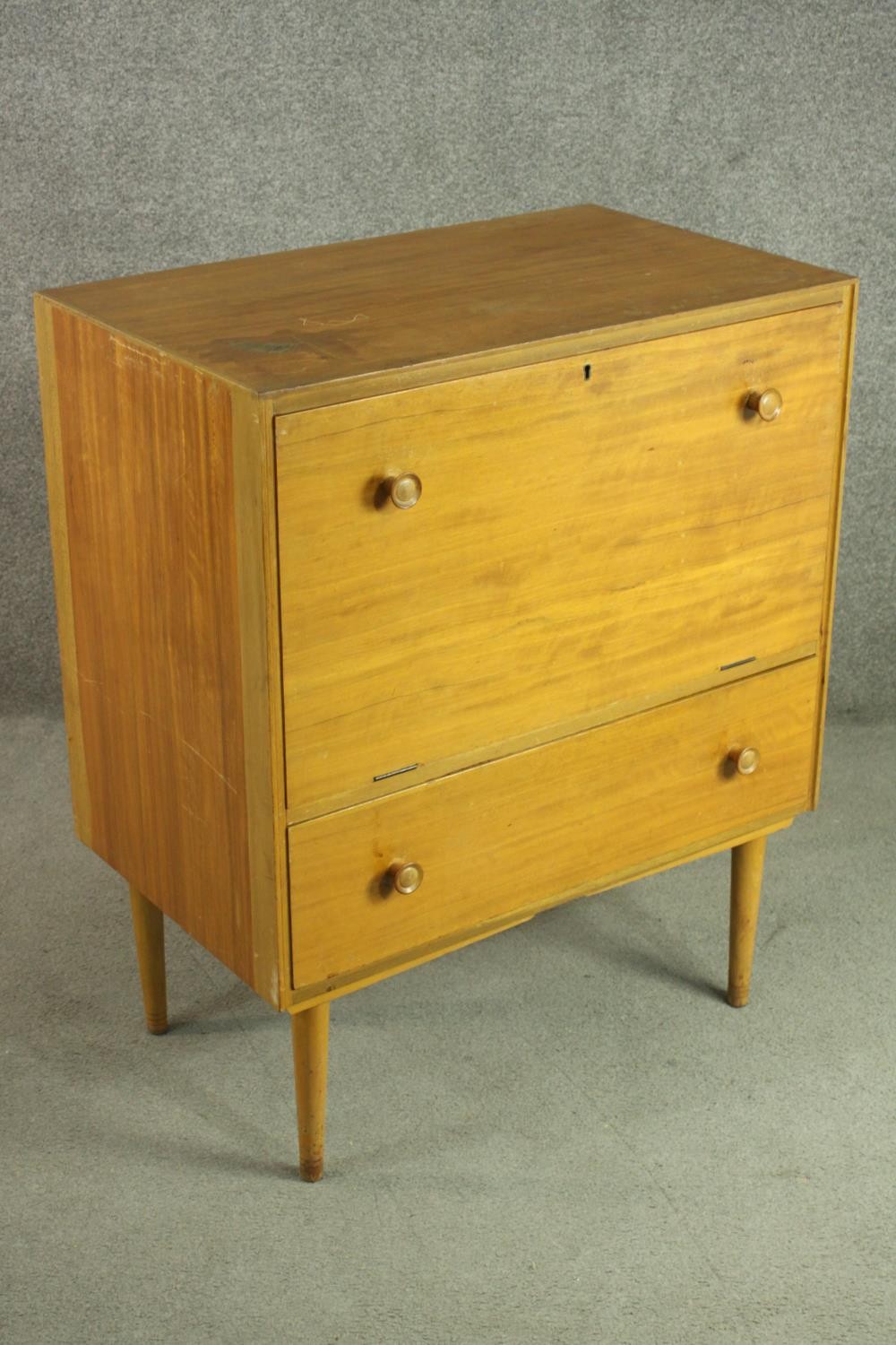 A circa 1950s teak cabinet, with a fall front enclosing a pull-out section, over a single drawer, on - Image 5 of 7