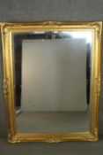 A large 19th century style rectangular mirror, with a bevelled mirror plate in a gilt frame, with