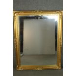 A large 19th century style rectangular mirror, with a bevelled mirror plate in a gilt frame, with