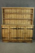 A vintage Continental rustic pine dresser, the plate rack with two shelves and a plank back, over