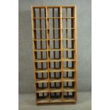 A 20th century pine pigeonhole unit, with nine tiers of three recesses, on a plinth base. H.200 W.86