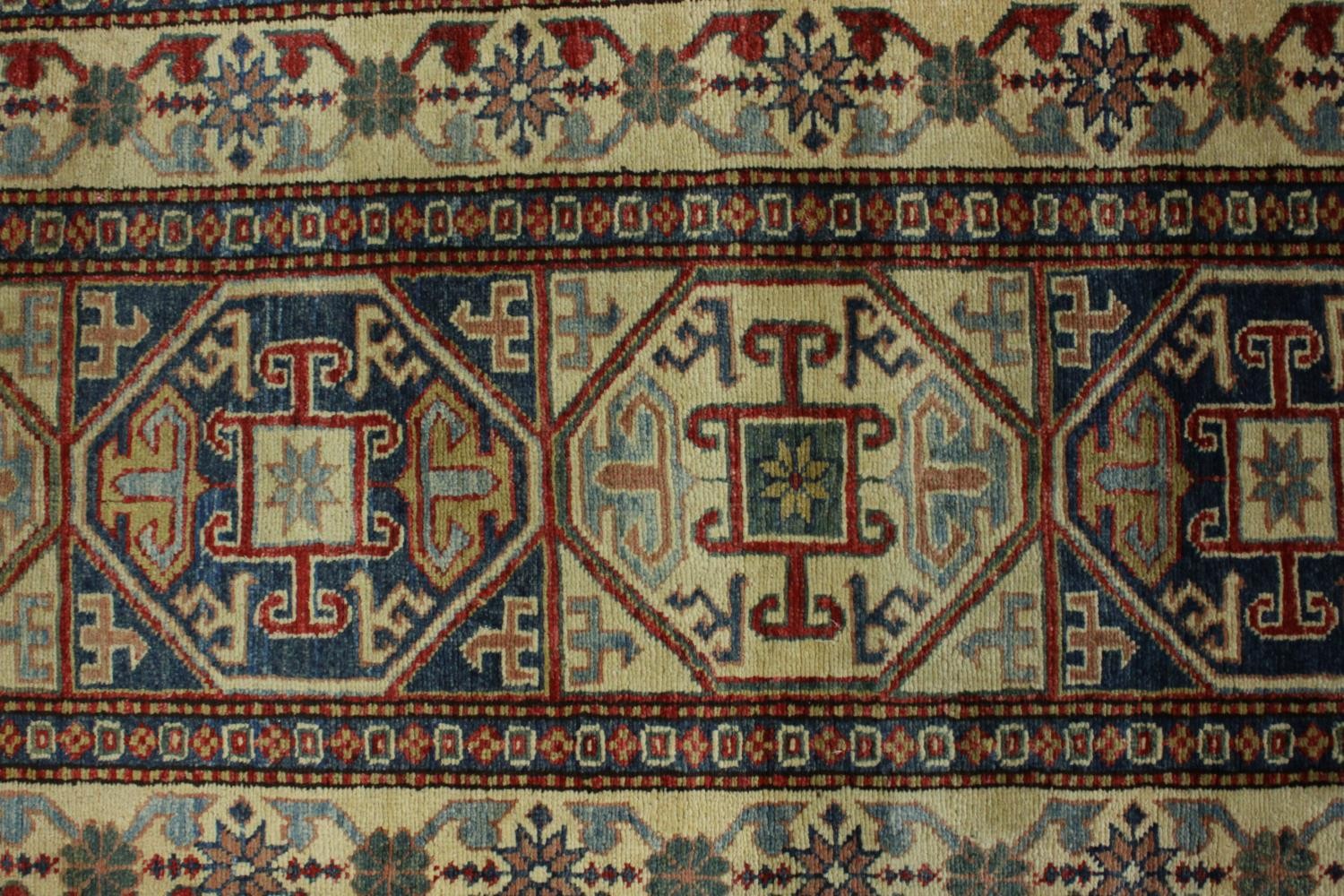 A hand made blue ground Chechen carpet. L.260 W.74cm. - Image 4 of 7