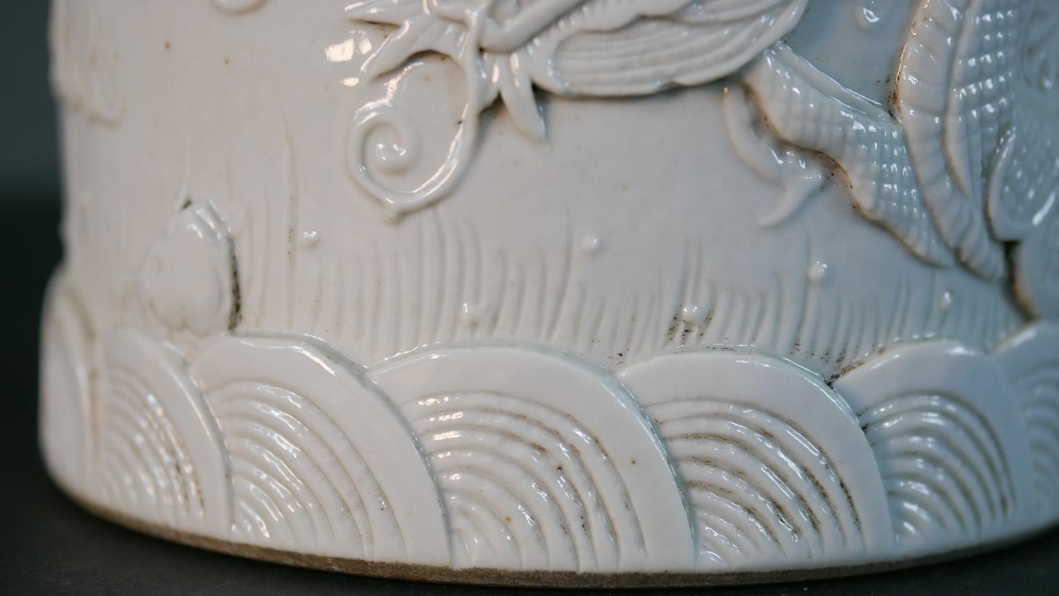 A Chinese blanc de chine relief porcelain dragon among the waves design brush pot. Impressed - Image 3 of 9