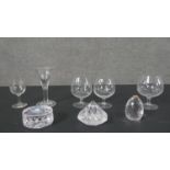 A collection of cut glass, including a pair of etched brandy glasses decorated with ladies
