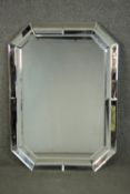 An Art Deco style mirror, of recangular form with canted corners, with a bevelled mirror plate,