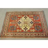 A hand made red ground Chechen rug. L.118 W.90cm.