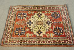 A hand made red ground Chechen rug. L.118 W.90cm.