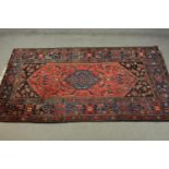 A hand made red ground Persian Hamadan carpet. L.210 W.129cm.