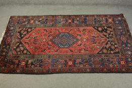 A hand made red ground Persian Hamadan carpet. L.210 W.129cm.