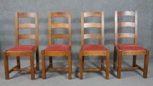 A set of four continental hardwood ladder back dining chairs, the drop-in seat upholstered in