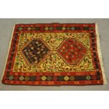 A hand made beige ground Persian Qashqai Sumac rug. L.100 W.77cm.