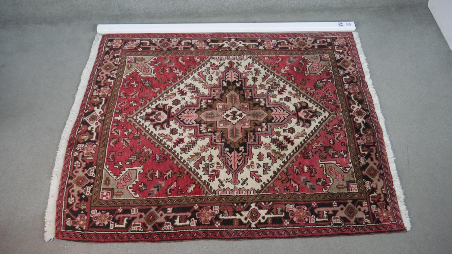 A hand made Persian Heriz carpet with central medallion on a madder field. L.201 W.158cm - Image 2 of 8