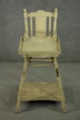 An Edwardian painted child's metamorphic high chair, converting from a high chair to a desk and