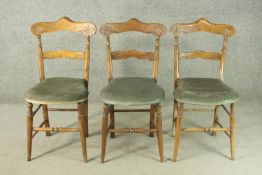A set of three French bar back dining chairs, with green velour seats, on turned splayed legs joined