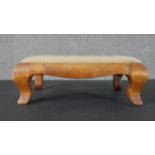 A satinwood footstool, with an embroidered seat, on cabriole legs. H.12 W.35 D.26cm
