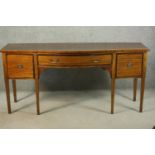 A George III style Edwardian mahogany and line inlaid sideboard, the bow front with a long drawer