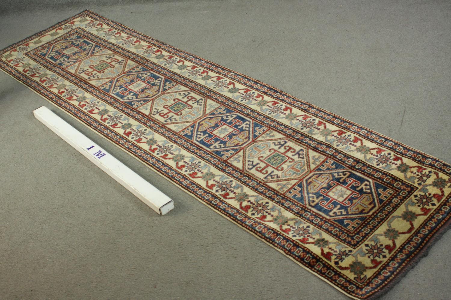 A hand made blue ground Chechen carpet. L.260 W.74cm. - Image 2 of 7