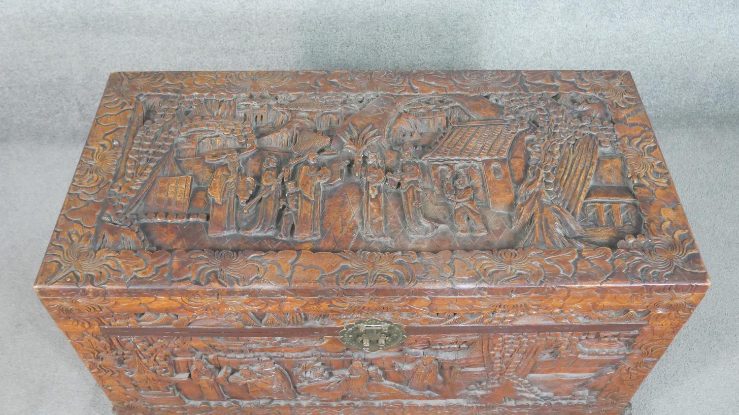 A 20th century Chinese camphorwood coffer, of rectangular form, the lid and sides ornately carved - Image 2 of 9