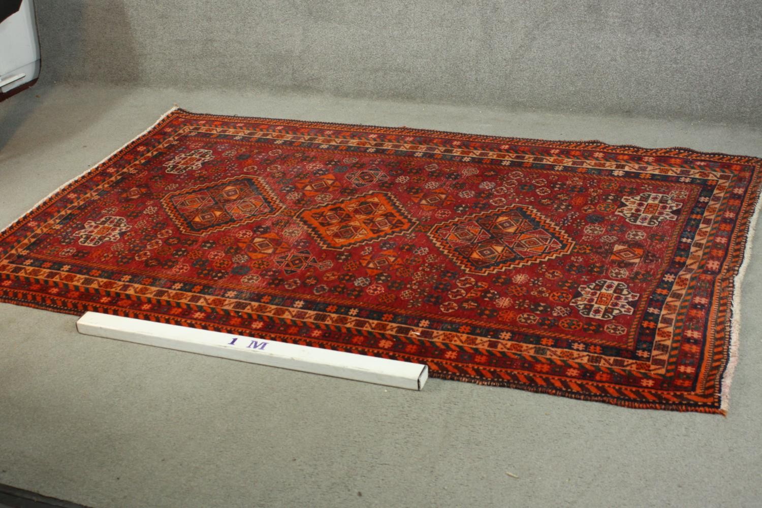 A hand made red ground Persian Qashqai carpet. L.236 W.155cm. - Image 2 of 6
