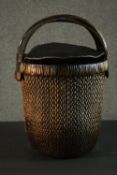 A Chinese woven rice basket with woven lid and bamboo handle. H.66 Dia. 40cm.
