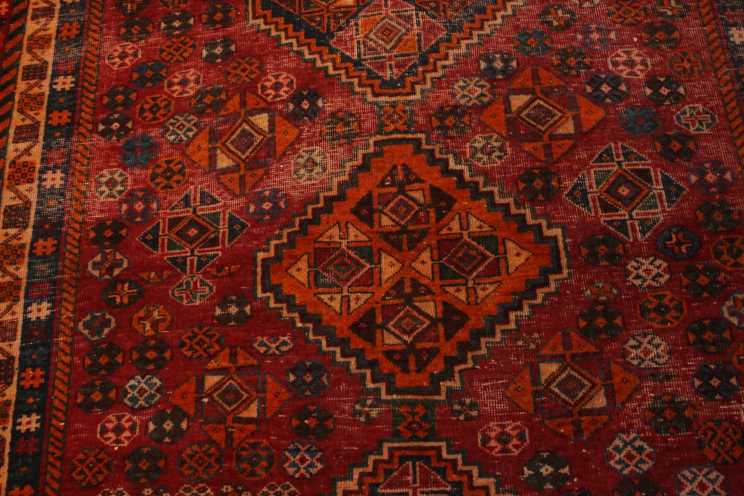 A hand made red ground Persian Qashqai carpet. L.236 W.155cm. - Image 6 of 6