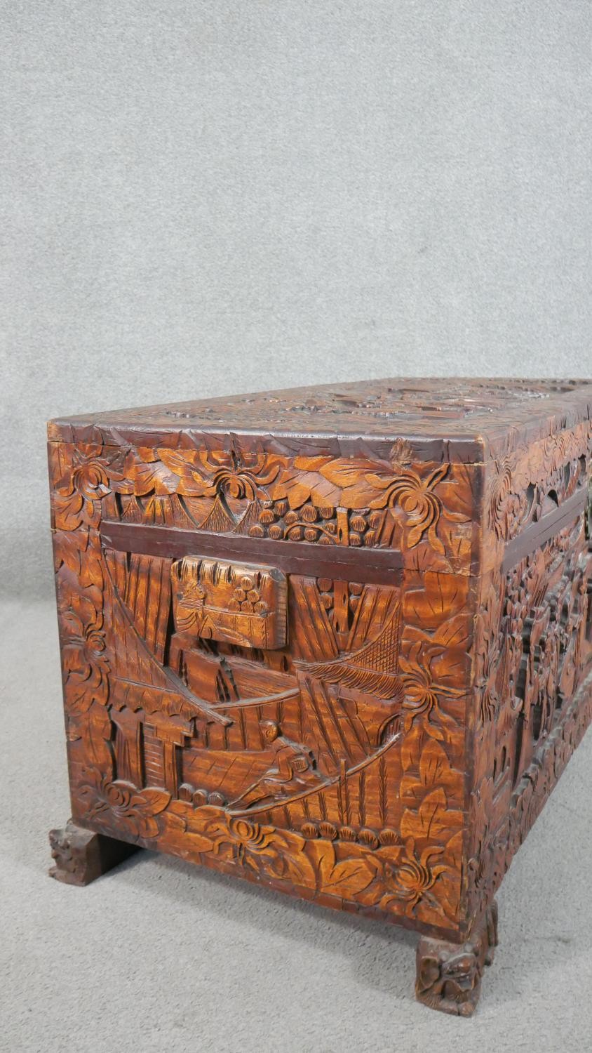 A 20th century Chinese camphorwood coffer, of rectangular form, the lid and sides ornately carved - Image 9 of 9