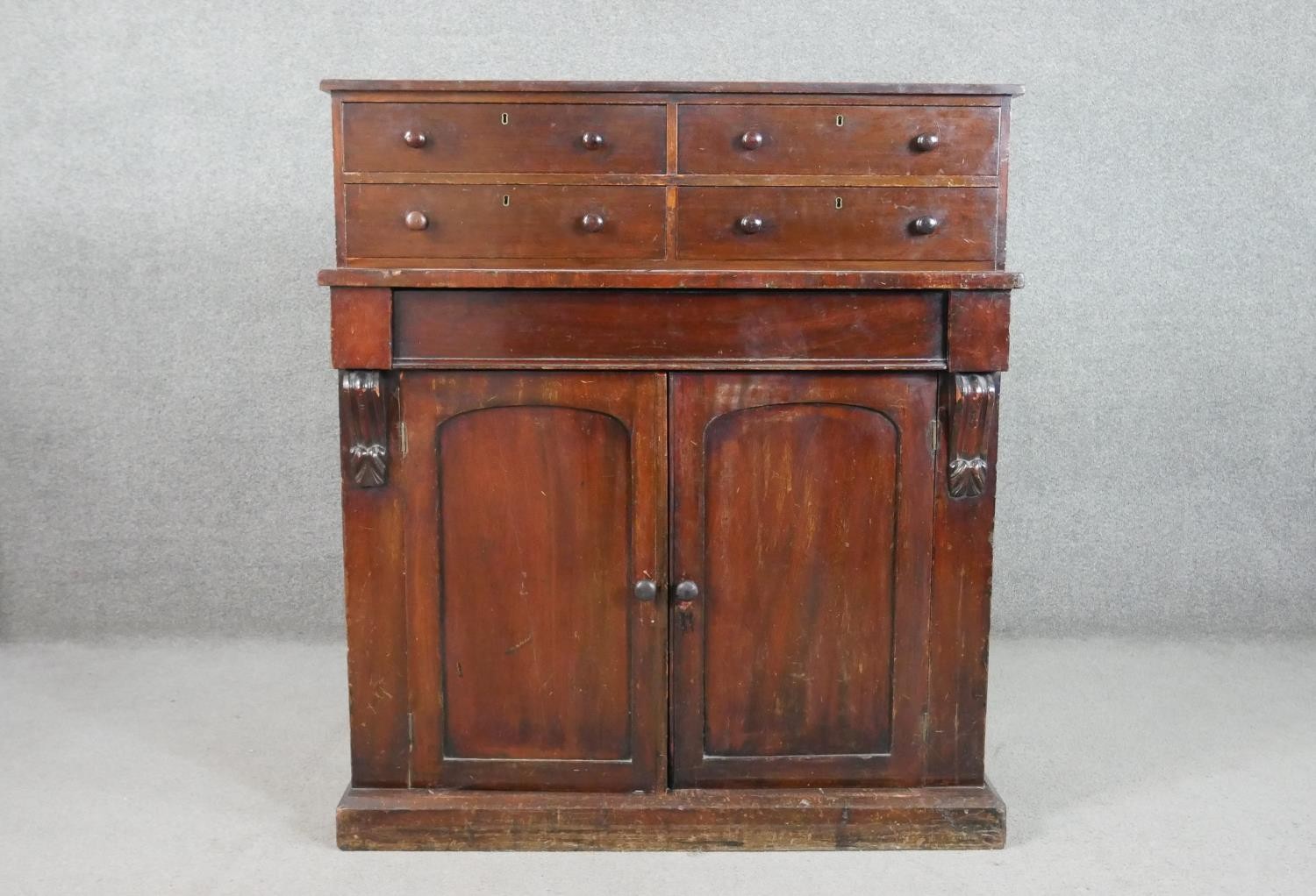 A Victorian mahogany chiffonier, surmounted by a section with two pairs of short drawers, over a