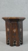 A Middle Eastern hardwood octagonal occasional table, ornately carved, and inlaid with bone. H.45