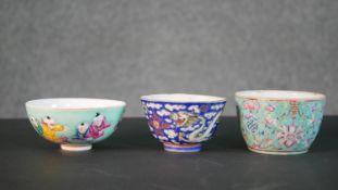 Three hand painted Chinese porcelain bowls, one decorated with clouds and dragons on a blue