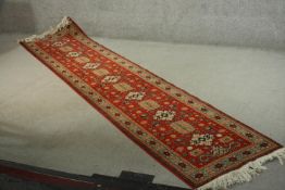 A hand made red ground Russian Shirvan runner. L.330 W.75cm.