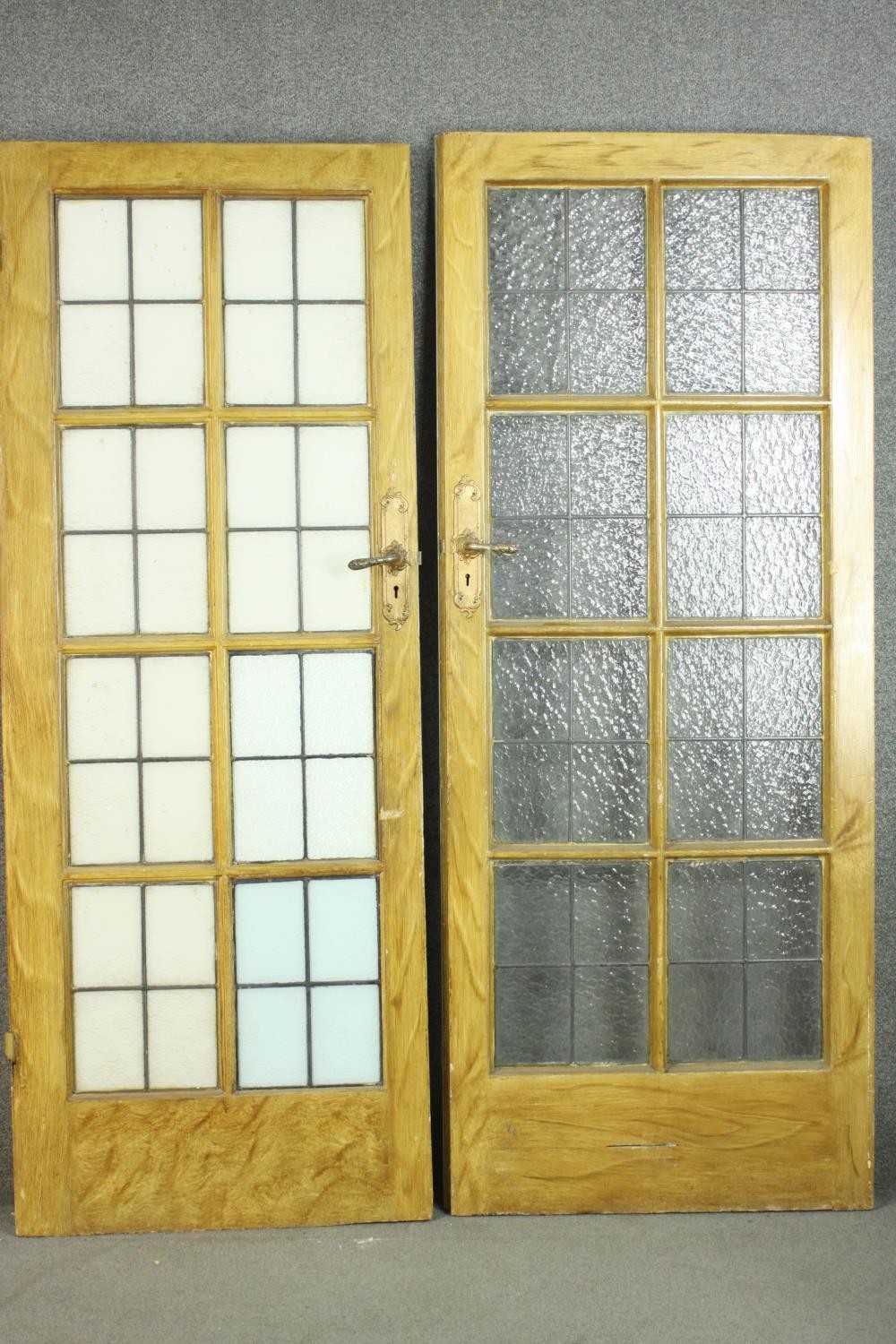 A pair of vintage simulated oak doors, lead set with textured glass panels...