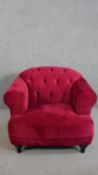 A contemporary Harto armchair, upholstered in crimson suede style fabric, with a buttoned back,