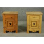 A pair of late 20th century pine bedside cabinets, with a single drawer over a cupboard door with