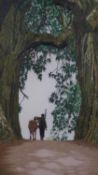 A framed embroidery of a young boy and a cow walking under trees, monogrammed TZ. H.88 W.64cm