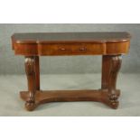 A Victorian Duchess style walnut dressing table, the shaped top with a central breakfront drawer, on