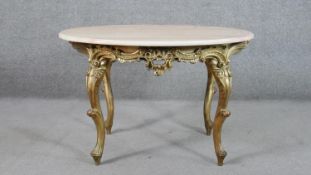 A Continental, probably Italian, carved giltwood table, the circular white marble top with a moulded