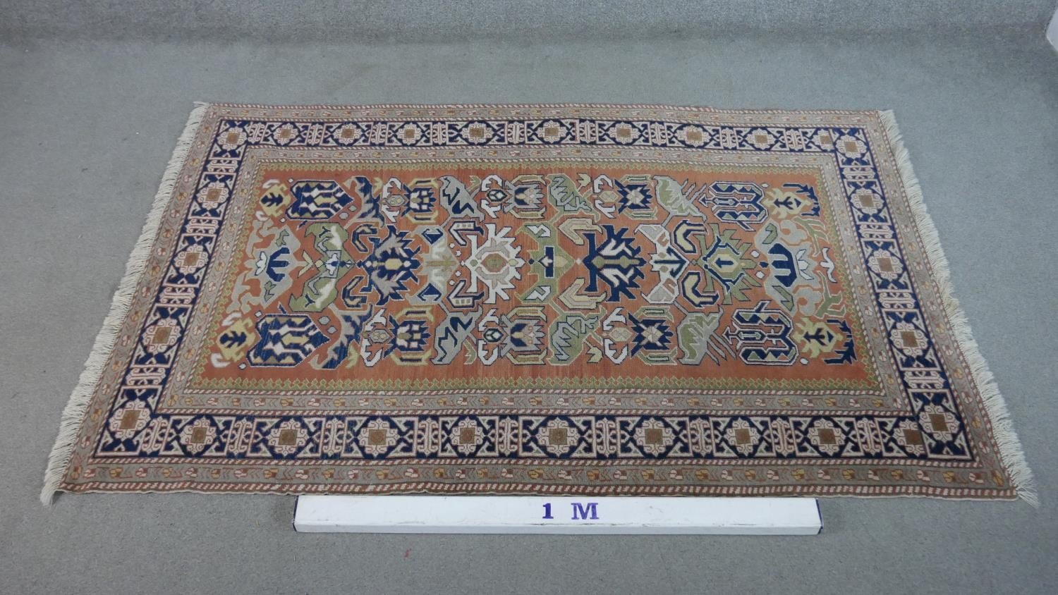 A handmade Russian Shirvan carpet with repeating stylised motifs on a pale terracotta ground - Image 2 of 7