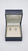 A boxed pair of aquamarine and 9ct gold stud earrings, each set with an oval mixed cut aquamarine,