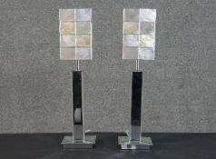 A pair of contemporary mirrored table lamps, the base formed from panels of bevelled mirror, the